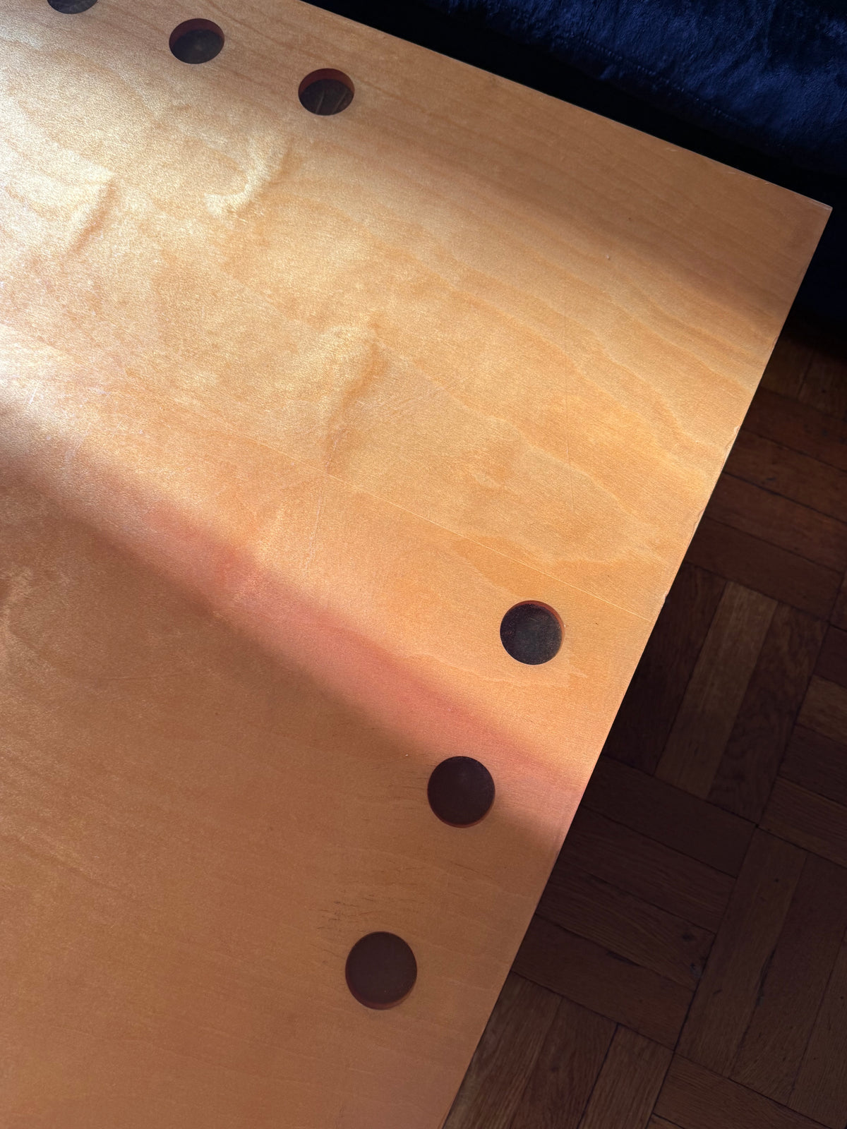 handmade modernist plywood coffee table with aluminum legs and red box underneath