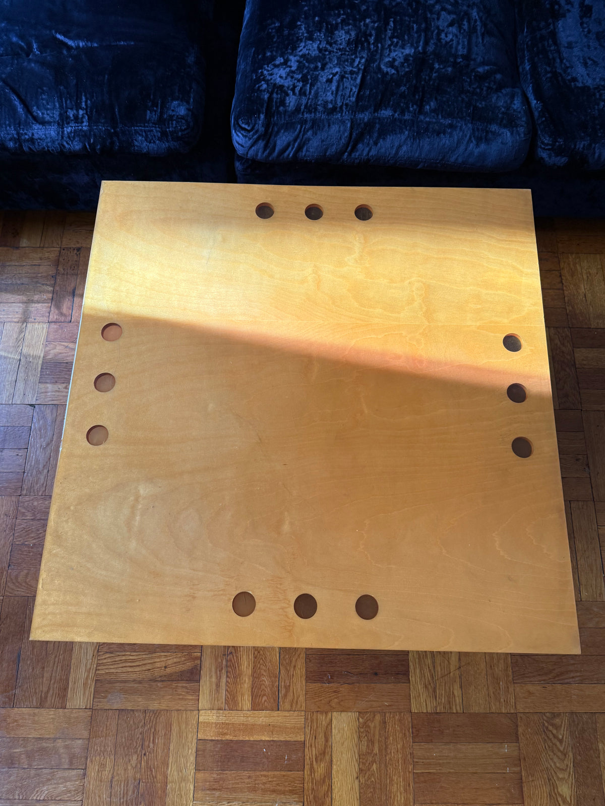 handmade modernist plywood coffee table with aluminum legs and red box underneath