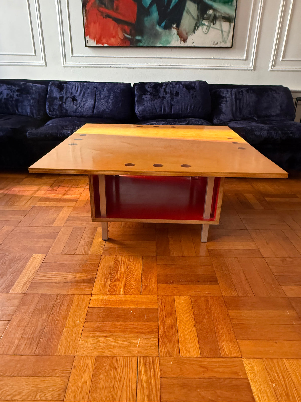 handmade modernist plywood coffee table with aluminum legs and red box underneath