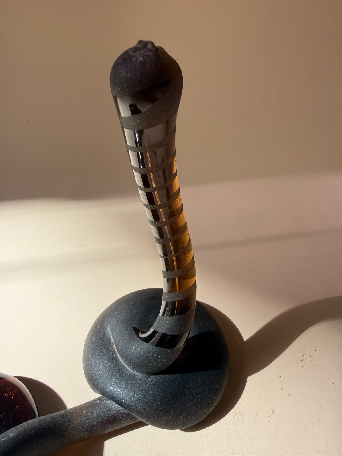 pair of handblown amber glass snake-like abstract sculptures