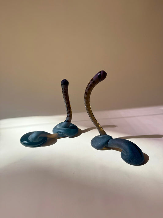 pair of handblown amber glass snake-like abstract sculptures