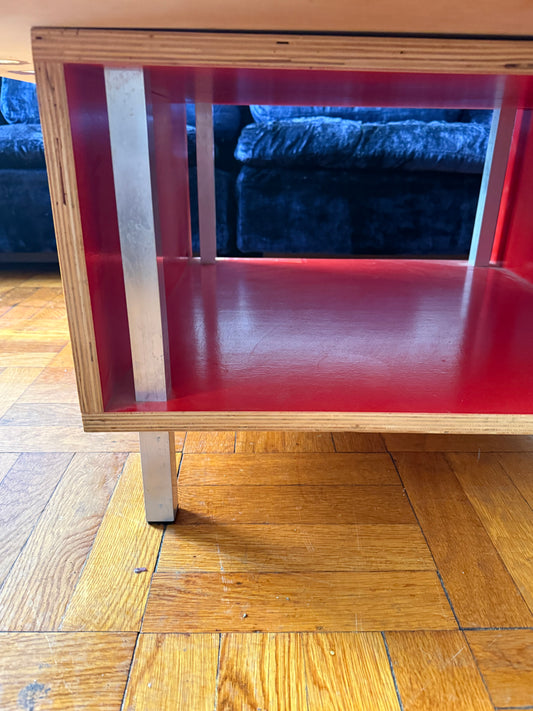 handmade modernist plywood coffee table with aluminum legs and red box underneath