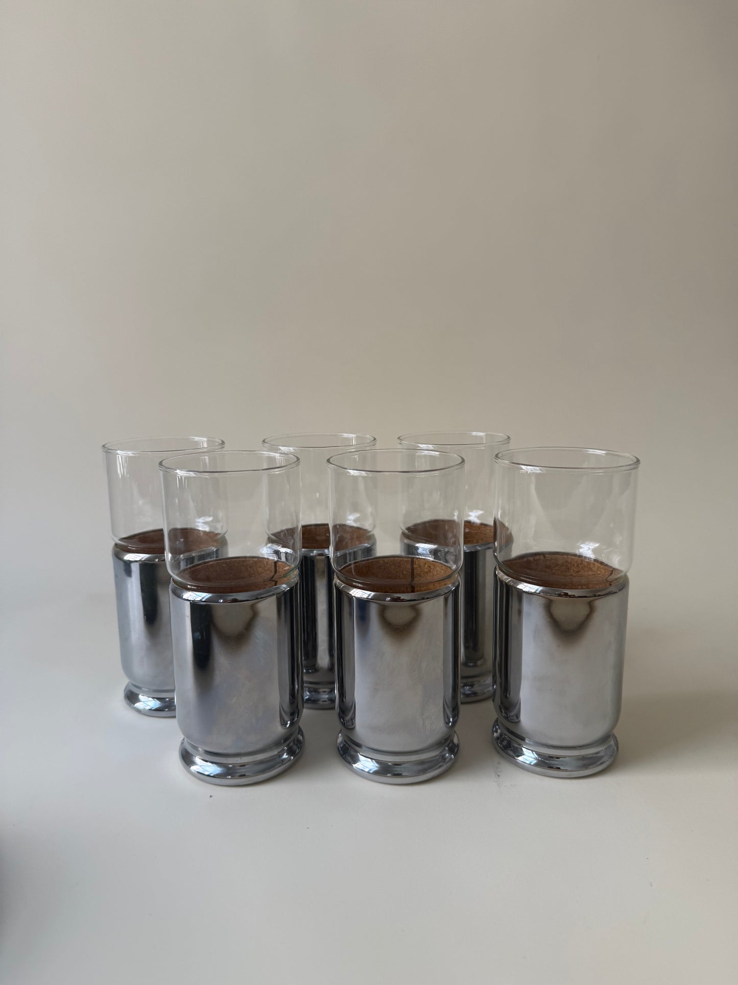 set of 6 space age drinking glasses with cork lined chrome covers