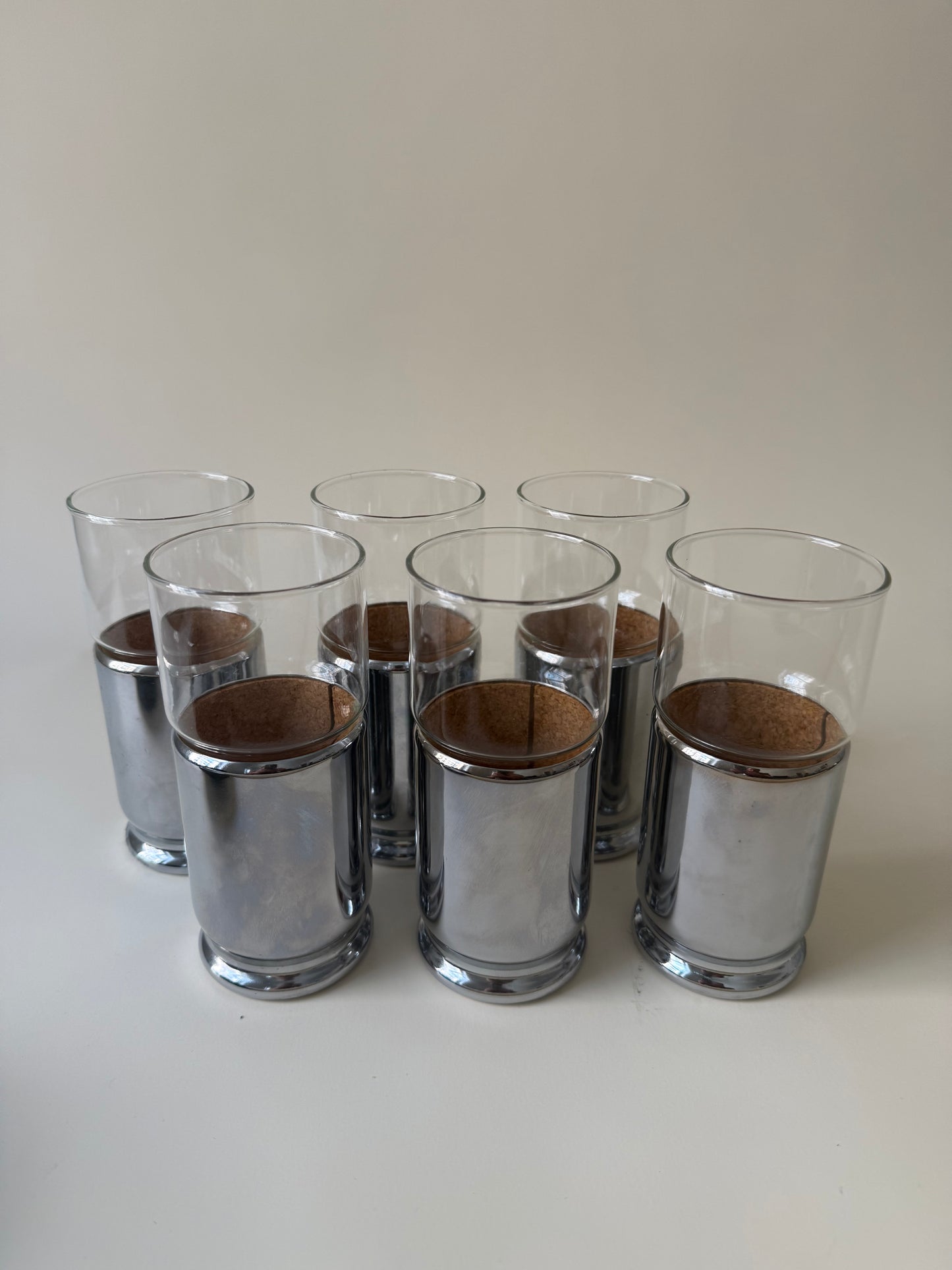 set of 6 space age drinking glasses with cork lined chrome covers