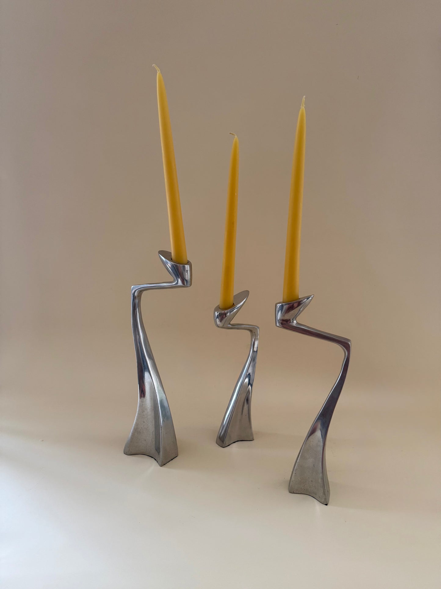 1980s set of three aluminum "swan" candlestick holders designed by Matthew Hilton