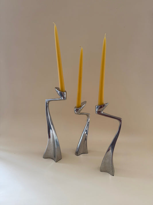 1980s set of three aluminum "swan" candlestick holders designed by Matthew Hilton
