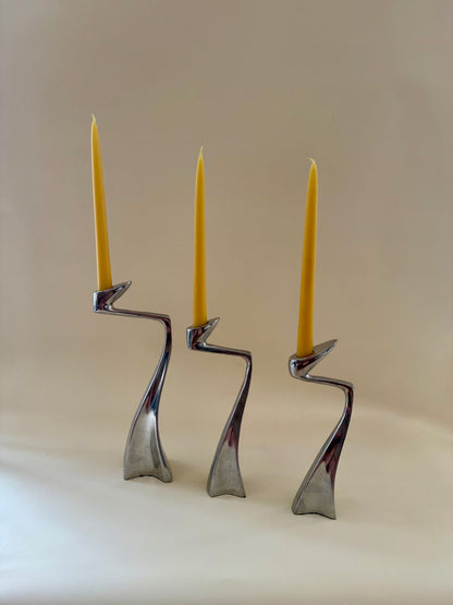 1980s set of three aluminum "swan" candlestick holders designed by Matthew Hilton