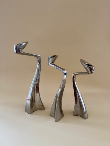 1980s set of three aluminum "swan" candlestick holders designed by Matthew Hilton