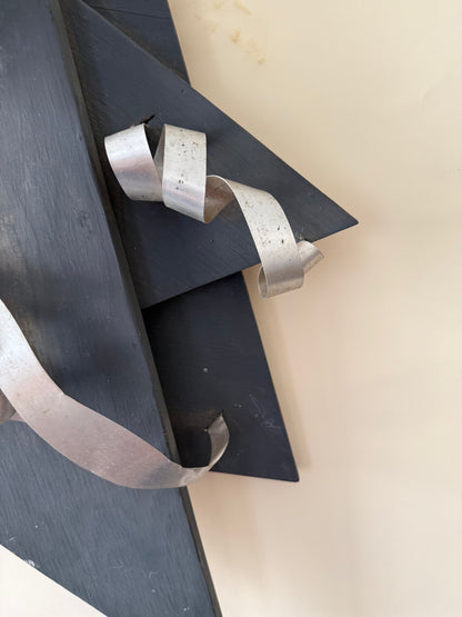 wood and metal abstract wall sculpture in black and and silver