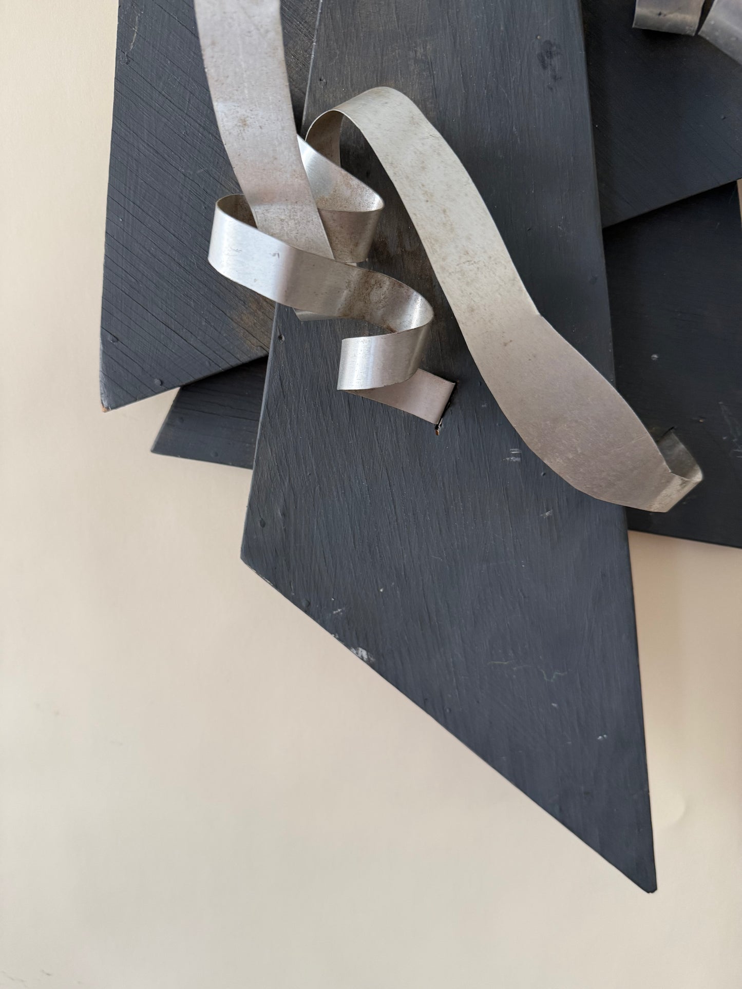wood and metal abstract wall sculpture in black and and silver